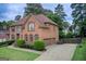 Charming two-story brick home with a well-manicured front yard, a circular driveway, and an attached garage at 1952 Sugarstone Dr, Lawrenceville, GA 30043