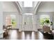 Bright foyer with hardwood floors, arched doorways, and a decorative front door at 1952 Sugarstone Dr, Lawrenceville, GA 30043