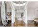 Grand foyer with high ceilings, wooden floors, and white columns at 1952 Sugarstone Dr, Lawrenceville, GA 30043