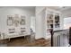 Hallway landing with hardwood floors, a bench, and built-in shelving at 1952 Sugarstone Dr, Lawrenceville, GA 30043