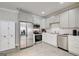 Modern kitchen with stainless steel appliances, white cabinetry, and sleek countertops for a clean, stylish design at 1952 Sugarstone Dr, Lawrenceville, GA 30043