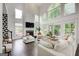 Bright living room features large windows, a fireplace, and a plush white sectional at 1952 Sugarstone Dr, Lawrenceville, GA 30043