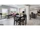 Open-concept living area with natural light, neutral tones, and tile floors, connecting dining and relaxing spaces at 1952 Sugarstone Dr, Lawrenceville, GA 30043