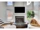 Open-concept living room with a cozy fireplace and large windows offering natural light at 1952 Sugarstone Dr, Lawrenceville, GA 30043