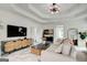 Bright living room with a tray ceiling, marble floors and a cozy sofa creating a warm and inviting ambiance at 1952 Sugarstone Dr, Lawrenceville, GA 30043