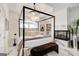Elegant main bedroom with four poster bed, chandelier and fireplace has a relaxing and luxurious feel at 1952 Sugarstone Dr, Lawrenceville, GA 30043