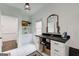 Bright mudroom boasts white cabinetry, stylish mirror, and convenient storage space for shoes and accessories at 1952 Sugarstone Dr, Lawrenceville, GA 30043