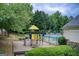 Community playground with play structure, benches, and nearby community pool at 1952 Sugarstone Dr, Lawrenceville, GA 30043