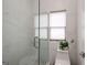 Bright, modern shower featuring a frameless glass door and gray marble tile at 1952 Sugarstone Dr, Lawrenceville, GA 30043