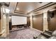 Home theater showcasing a large screen, surround sound speakers, comfortable seating, and custom design at 1952 Sugarstone Dr, Lawrenceville, GA 30043