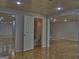 Basement area featuring an adjacent bathroom with toilet and doorway leading to other spaces at 902 Sweetbay Ct, Stockbridge, GA 30281