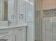Well-lit bathroom with a glass-door shower and modern vanity with ample storage at 902 Sweetbay Ct, Stockbridge, GA 30281