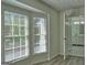 Bedroom featuring wood floors and bright natural light; bathroom is attached at 902 Sweetbay Ct, Stockbridge, GA 30281