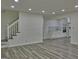 Bright living room featuring modern flooring and a view of the staircase and kitchen at 902 Sweetbay Ct, Stockbridge, GA 30281