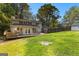A sprawling backyard showcasing a wooden deck, well-maintained lawn, and home exterior at 103 Chipstone Ct, Peachtree City, GA 30269