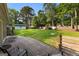 Spacious backyard with a wooden deck, lush green lawn, storage shed, and hot tub at 103 Chipstone Ct, Peachtree City, GA 30269