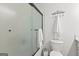 Bathroom features a frosted glass shower, toilet, and decorative wall rack, blending style and function at 103 Chipstone Ct, Peachtree City, GA 30269