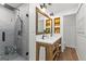 Modern bathroom features double sinks, a wood vanity, and a frameless glass shower at 103 Chipstone Ct, Peachtree City, GA 30269