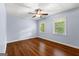 Empty bedroom features hardwood flooring, a ceiling fan, and natural light from two windows at 103 Chipstone Ct, Peachtree City, GA 30269