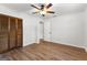 Bedroom features wood-look floors, a ceiling fan, a large closet and entry to another room at 103 Chipstone Ct, Peachtree City, GA 30269