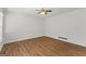 Empty bedroom featuring hardwood floors, ceiling fan, and crisp white walls and trim at 103 Chipstone Ct, Peachtree City, GA 30269