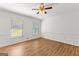 Empty bedroom with hardwood floors, natural light from two windows, and classic white walls at 103 Chipstone Ct, Peachtree City, GA 30269