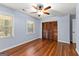 Empty bedroom features hardwood floors, a ceiling fan, two windows and closet with wood doors at 103 Chipstone Ct, Peachtree City, GA 30269