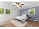 Neutral bedroom featuring hardwood floors, a ceiling fan, and natural light from windows at 103 Chipstone Ct, Peachtree City, GA 30269