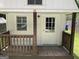 Cozy front porch with wooden railing leads to the main door, enhancing curb appeal at 103 Chipstone Ct, Peachtree City, GA 30269