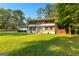 Charming two-story home with double balconies, shutters, a brick facade, and a well-manicured lawn at 103 Chipstone Ct, Peachtree City, GA 30269