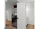 Hallway with stainless steel refrigerator and bathroom with open door and white vanity at 103 Chipstone Ct, Peachtree City, GA 30269