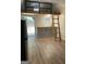 Well-lit interior features kitchenette, ladder to loft, and view of the pool area at 103 Chipstone Ct, Peachtree City, GA 30269