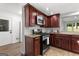 Modern kitchen features wood cabinets, stainless steel appliances, and granite countertops at 103 Chipstone Ct, Peachtree City, GA 30269