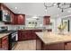 Modern kitchen features wood cabinets, stainless steel appliances, and granite countertops at 103 Chipstone Ct, Peachtree City, GA 30269