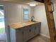 Modern kitchenette featuring gray cabinets, wood countertop, and ladder to the loft area at 103 Chipstone Ct, Peachtree City, GA 30269