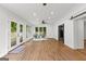 Spacious living room with hardwood floors, a ceiling fan, large windows, and a glass paneled door to deck at 103 Chipstone Ct, Peachtree City, GA 30269