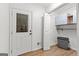 Mud room with access to backyard, closet for storage, and hardwood floors at 103 Chipstone Ct, Peachtree City, GA 30269