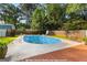 Backyard with a large in-ground pool, wooden deck, shed, and landscaped surroundings at 103 Chipstone Ct, Peachtree City, GA 30269