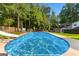 Beautiful backyard pool with slide, mature trees, hot tub and patio area for relaxation at 103 Chipstone Ct, Peachtree City, GA 30269