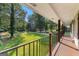 Covered porch with views of mature trees, a green lawn, and blue sky, offering a serene outdoor space at 103 Chipstone Ct, Peachtree City, GA 30269