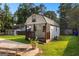 Charming backyard shed with porch, surrounded by green grass and mature trees at 103 Chipstone Ct, Peachtree City, GA 30269