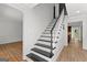 Staircase featuring black treads and white risers and view into the main living area at 103 Chipstone Ct, Peachtree City, GA 30269