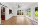 Bright sunroom with hardwood floors, large windows, and a passthrough to the kitchen at 103 Chipstone Ct, Peachtree City, GA 30269
