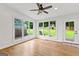 Bright sunroom with hardwood floors, large windows with backyard view, and a door to the deck at 103 Chipstone Ct, Peachtree City, GA 30269