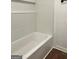 Close-up of a clean white tiled bathtub with built-in shelving at 1764 Cahoon Sw St, Atlanta, GA 30310