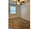 This bedroom offers a cozy atmosphere with plush carpeting, a ceiling fan, and a window for natural light at 1764 Cahoon Sw St, Atlanta, GA 30310