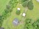 Aerial view of a house with multiple shelters on a green lot at 778 Leguin Mill Rd, Locust Grove, GA 30248