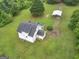 Aerial view of a two story home with green yard, shed and trees at 778 Leguin Mill Rd, Locust Grove, GA 30248