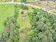 Aerial view of the property with a house surrounded by lush greenery and trees at 778 Leguin Mill Rd, Locust Grove, GA 30248