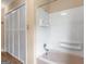 Bathroom features a shower/tub combo with white tile and sliding closet doors at 778 Leguin Mill Rd, Locust Grove, GA 30248